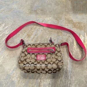 COACH Crossbody bag with heart shaped zipper monogram with pink trim and strap